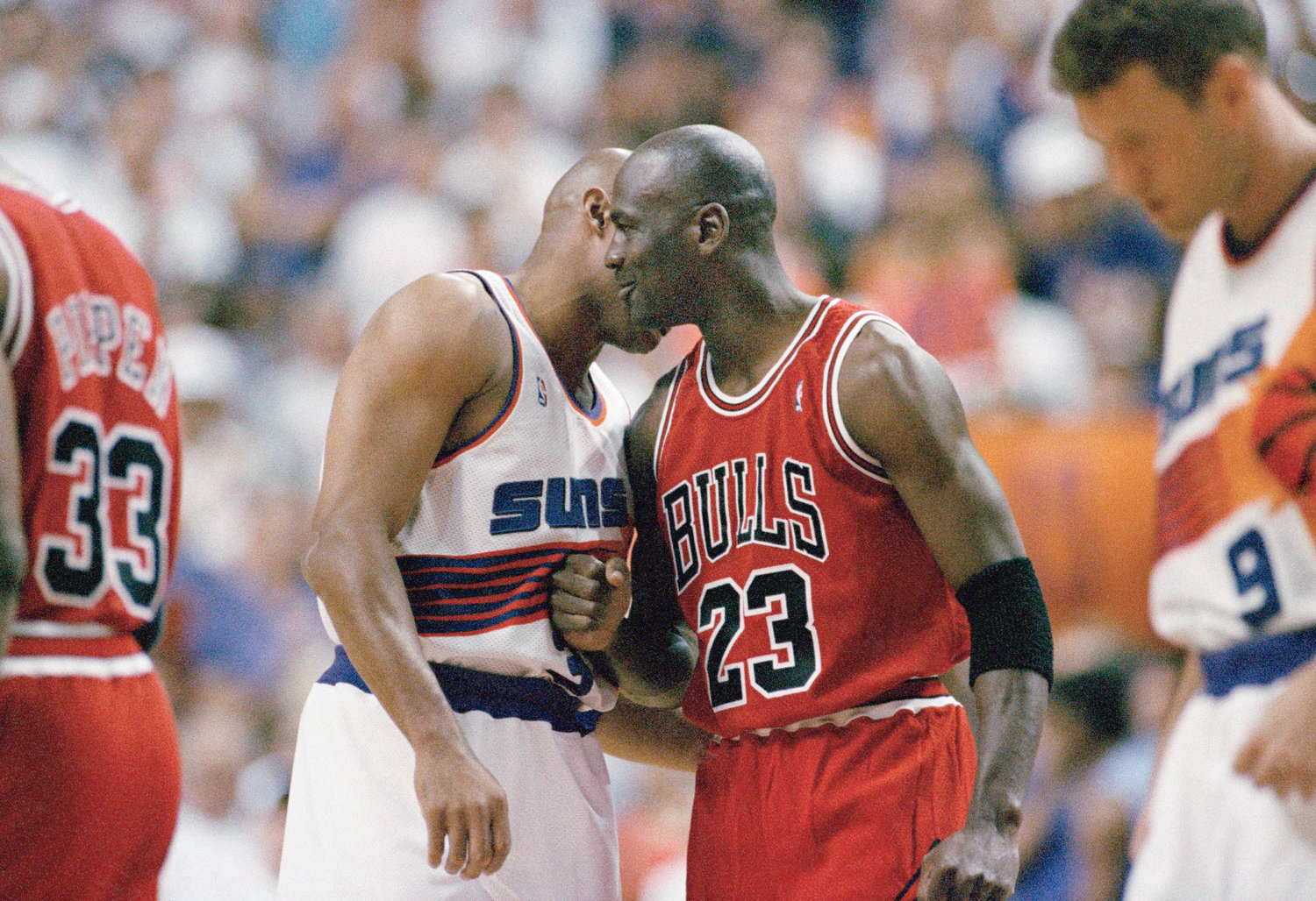 The Chicago Bulls' Michael Jordan (23) shows he's still friends with the Phoenix Suns Charles Barkley as they get set to play Game 6 of the NBA finals in Phoenix, June 20, 1993. (AP Photo/John Swart)