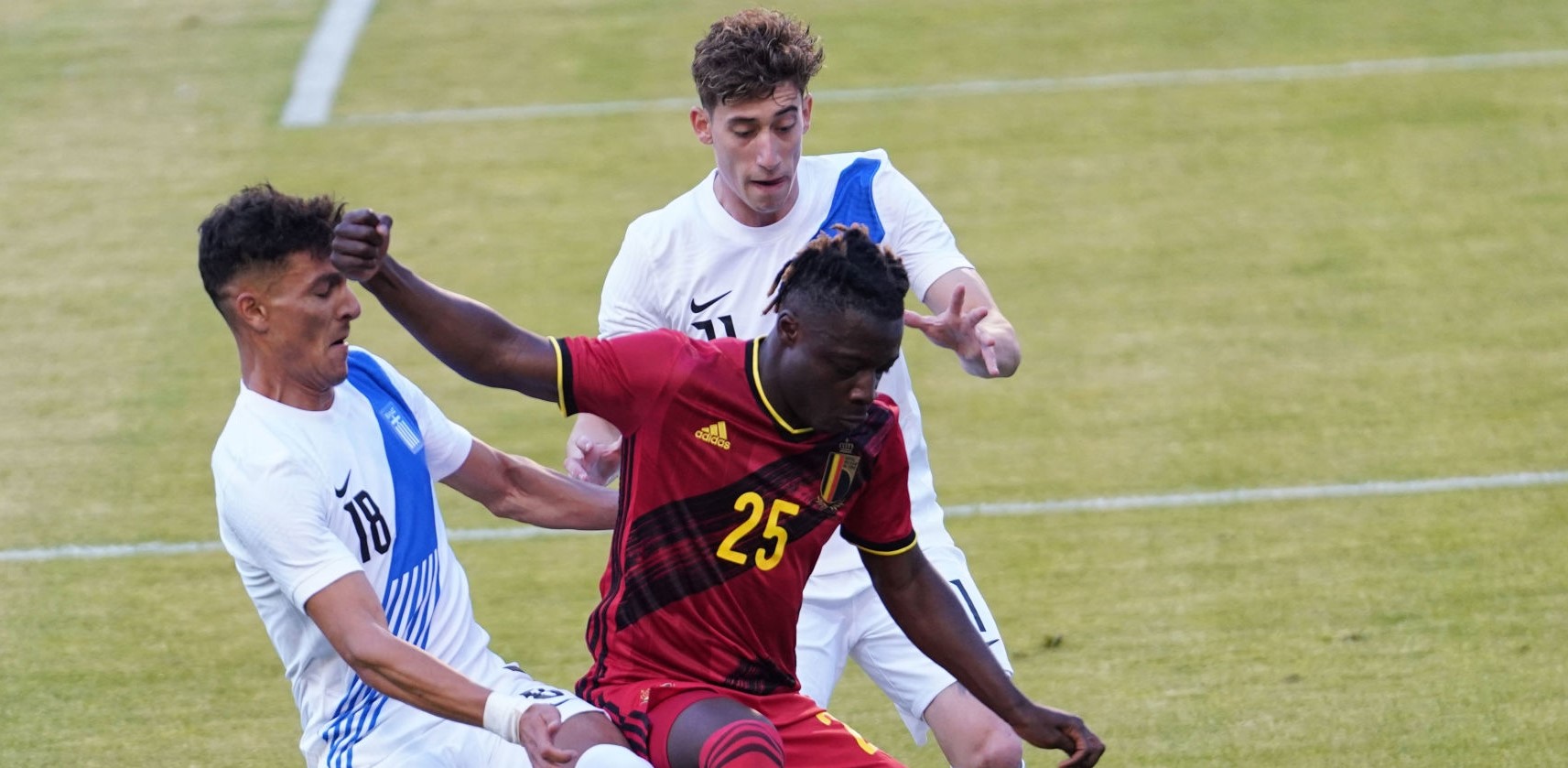 BRUSSELS, BELGIUM - JUNE 03: Jeremy Doku of Belgium competes for the ball with Dimitris Giannoulis of Greece  and Kostas (Konstantinos) Tsimikas of Greece  during the international friendly match between Belgium and Greece at King Baudouin Stadium on June 3, 2021 in Brussels, Belgium. (Photo by Sylvain Lefevre/Getty Images)