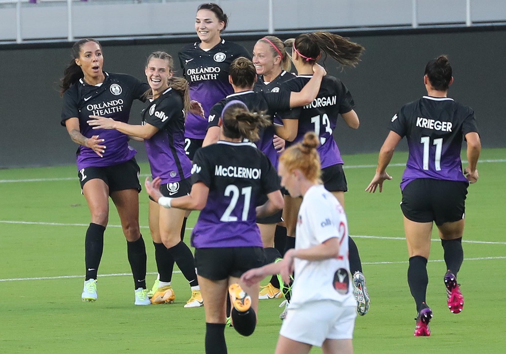 Orlando players celebrate after a Sydney Leroux goal during the Washington Spirit at Orlando Pride NWLS soccer game at Exploria Stadium in Orlando on Wednesday, April 21, 2021. (Stephen M. Dowell/Orlando Sentinel)